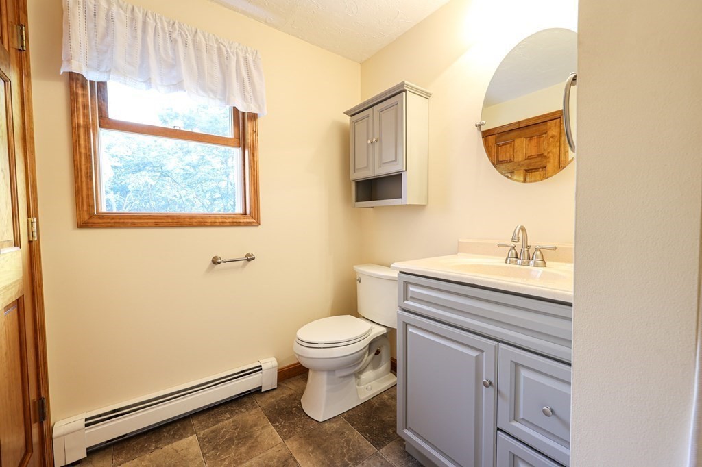 218 Lower Gore Road Webster, MA 01570 - Photo 12 of 40 a bathroom with a sink toilet and a mirror