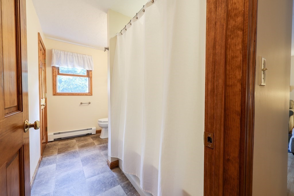 218 Lower Gore Road Webster, MA 01570 - Photo 13 of 40 a view of a bathroom with a shower and a toilet