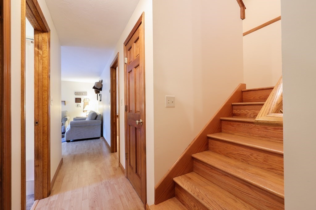 218 Lower Gore Road Webster, MA 01570 - Photo 14 of 40 a view of a hallway with wooden floor and staircase
