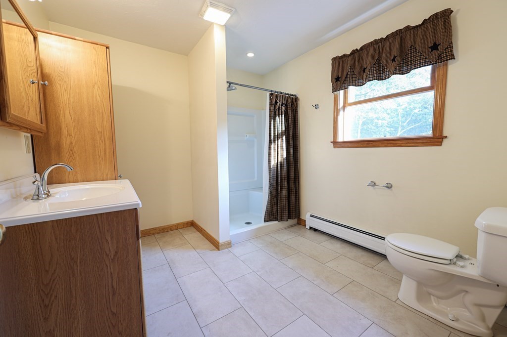 218 Lower Gore Road Webster, MA 01570 - Photo 18 of 40 a bathroom with a granite countertop sink toilet and shower