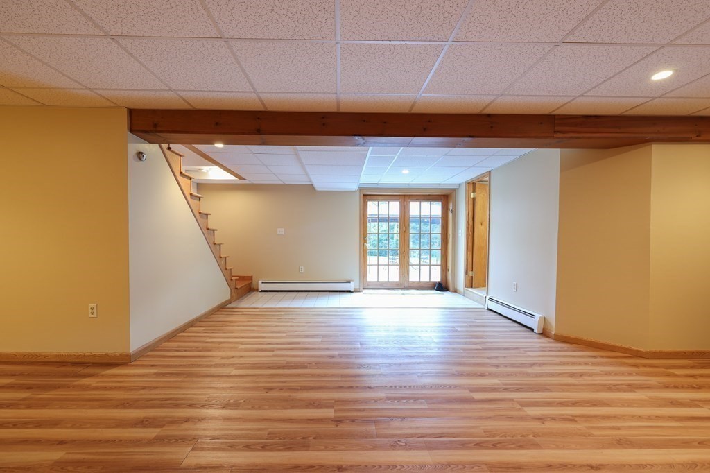 218 Lower Gore Road Webster, MA 01570 - Photo 24 of 40 a view of an empty room with wooden floor and a window