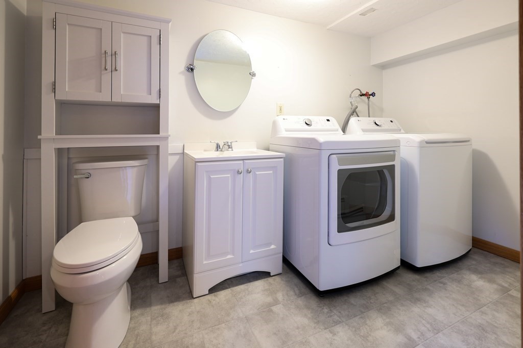 218 Lower Gore Road Webster, MA 01570 - Photo 26 of 40 a bathroom with a toilet sink and mirror