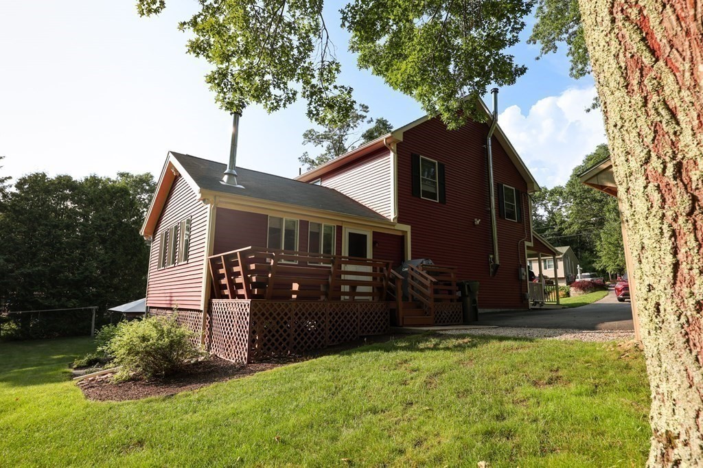 218 Lower Gore Road Webster, MA 01570 - Photo 30 of 40 a front view of a house with a yard and trees