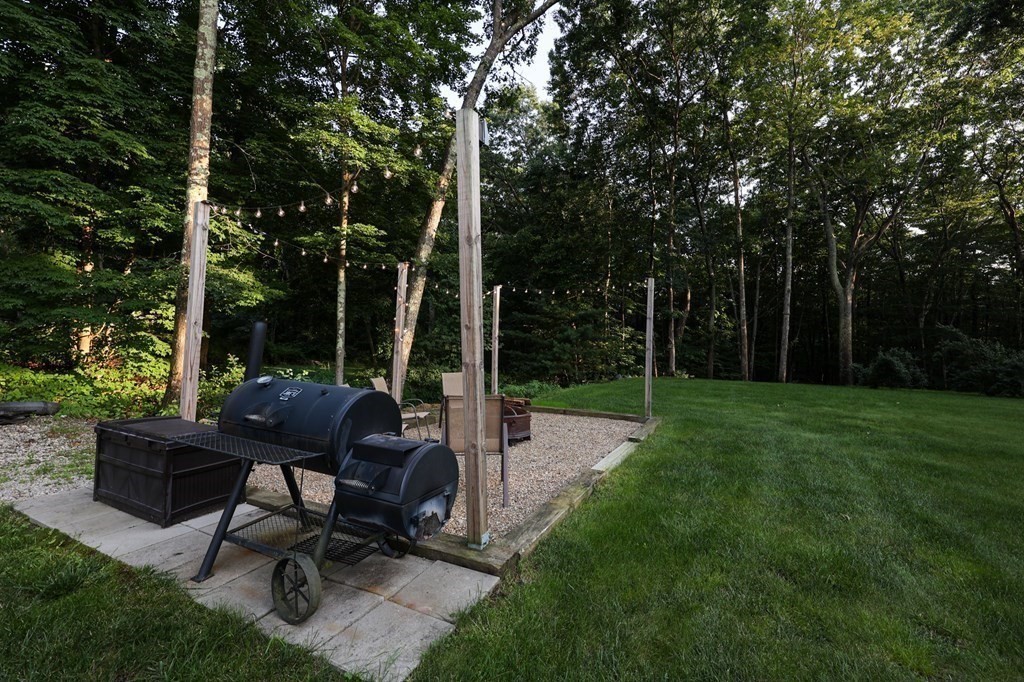218 Lower Gore Road Webster, MA 01570 - Photo 32 of 40 a view of a backyard with a sitting area and a garden