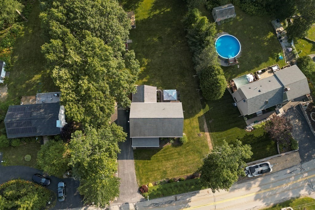 218 Lower Gore Road Webster, MA 01570 - Photo 37 of 40 an aerial view of a house with a swimming pool a yard and a fountain