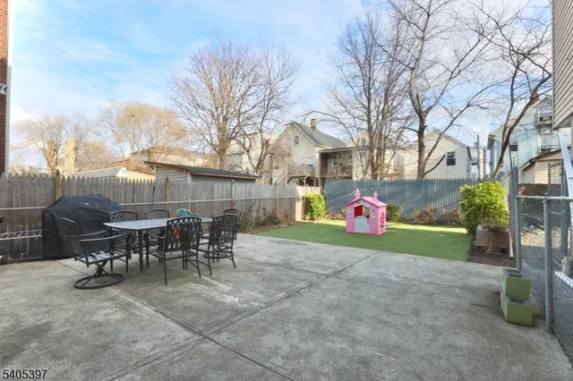 a view of a house with backyard and a tree