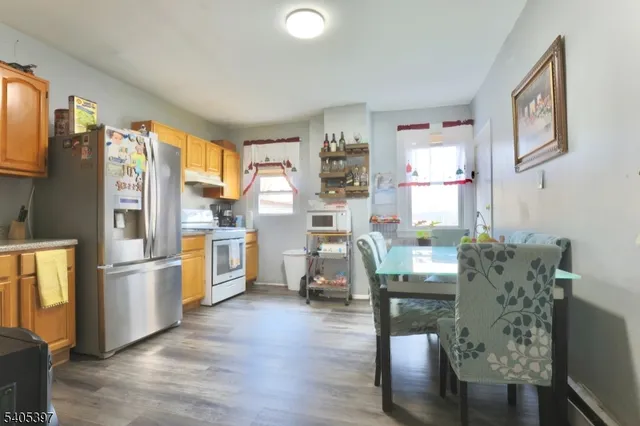 a living room with furniture and a kitchen