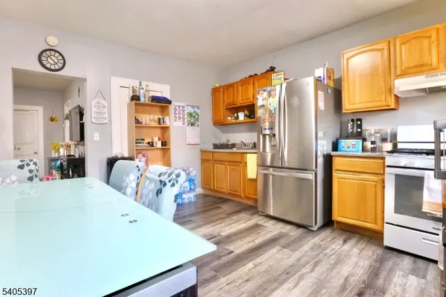 a kitchen with stainless steel appliances a refrigerator and a stove