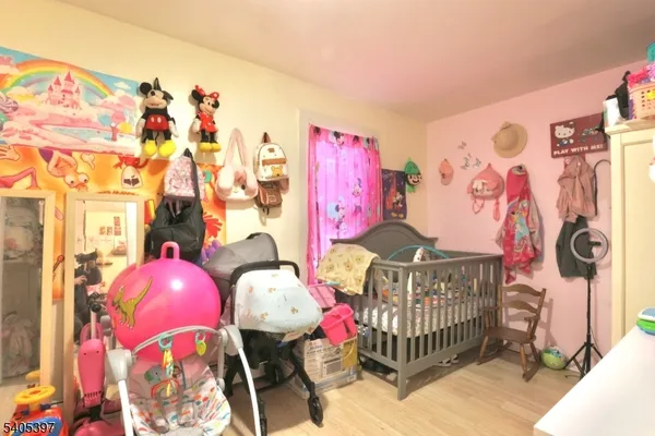 a bedroom with furniture and baby bed