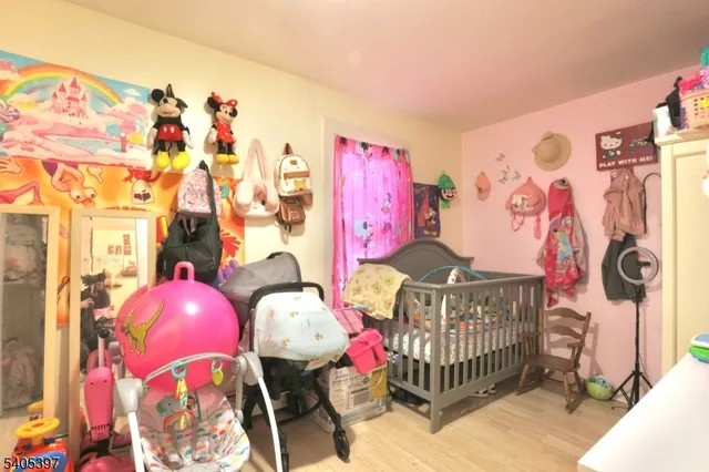 a bedroom with furniture and baby bed