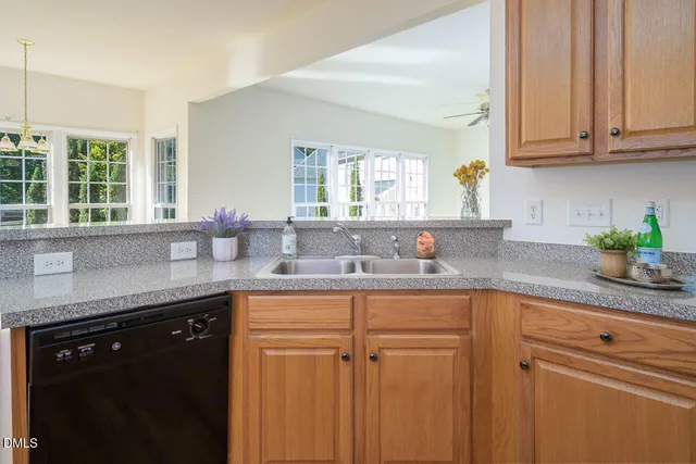 a view of an empty room with a fireplace and a window