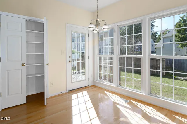 an empty room with windows and closet