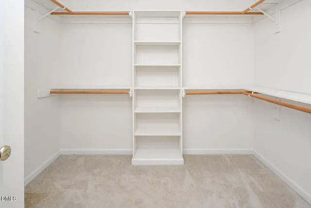 an aerial view of a house with swimming pool and large trees