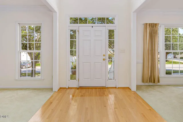 a view of a dining room with furniture and a window