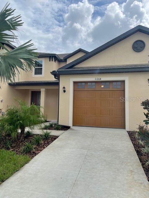a front view of a house with a garage