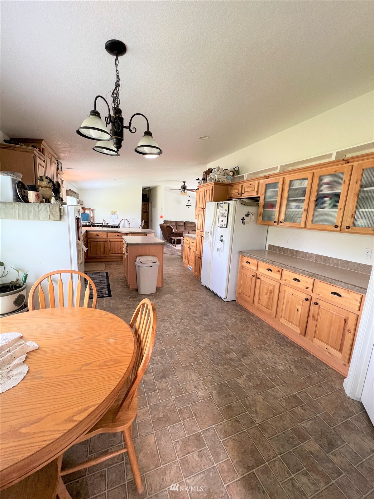 138 Miller Road Omak, WA 98841 - Photo 7 of 39 a living room with furniture a chandelier and kitchen view