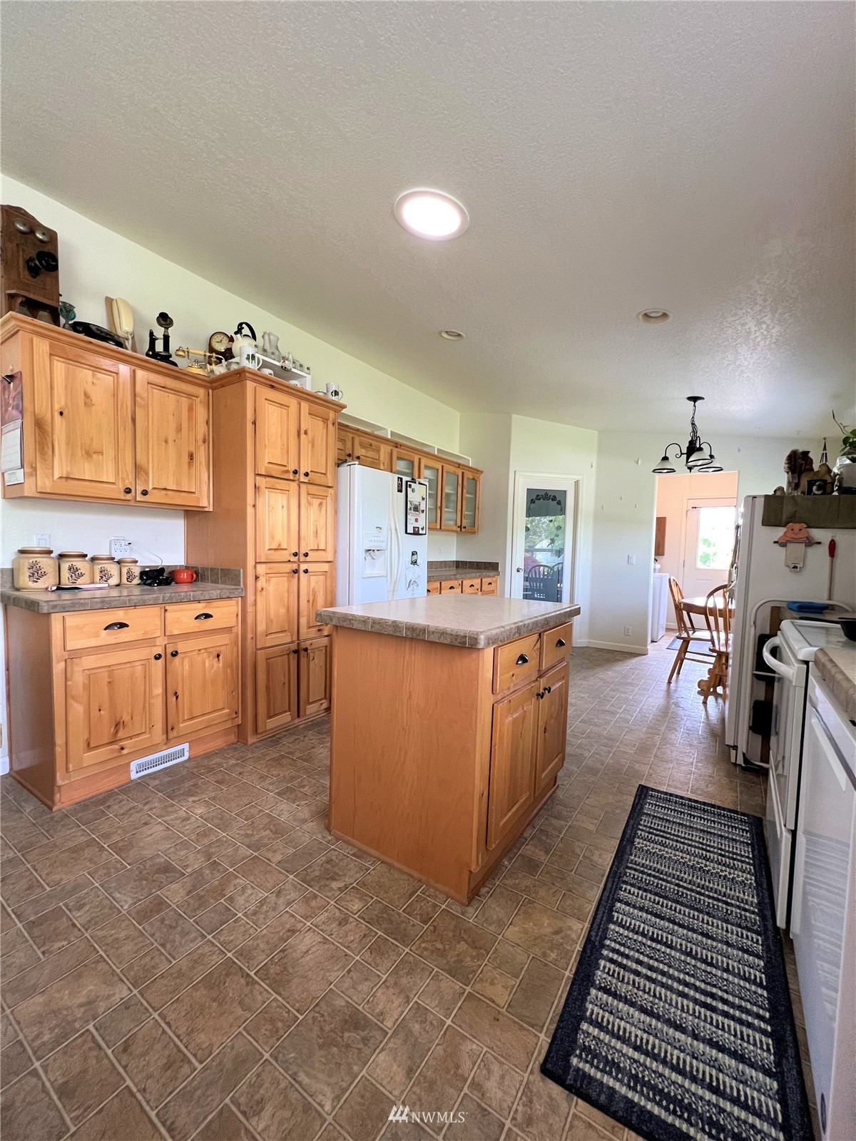 138 Miller Road Omak, WA 98841 - Photo 10 of 39 a kitchen with sink cabinets and wooden floor