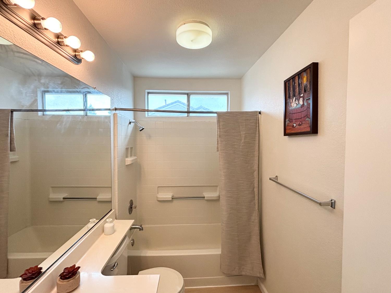6813 Springridge Way Elk Grove, CA 95758 - Photo 12 of 26 a bathroom with a bathtub and a shower