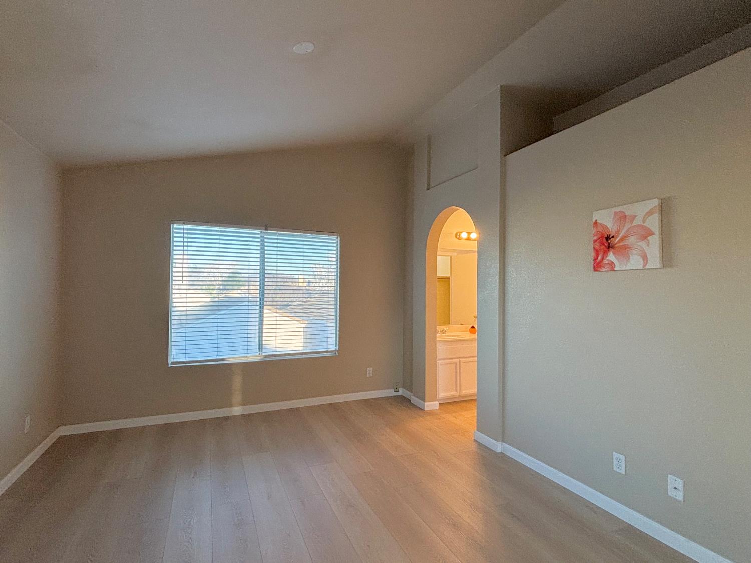 6813 Springridge Way Elk Grove, CA 95758 - Photo 14 of 26 an empty room with wooden floor and window