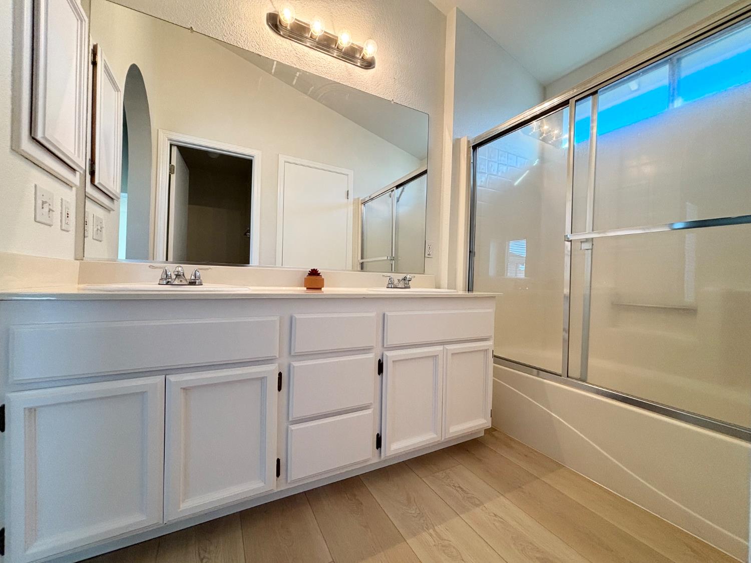 6813 Springridge Way Elk Grove, CA 95758 - Photo 16 of 26 a bathroom with a double vanity sink and mirror