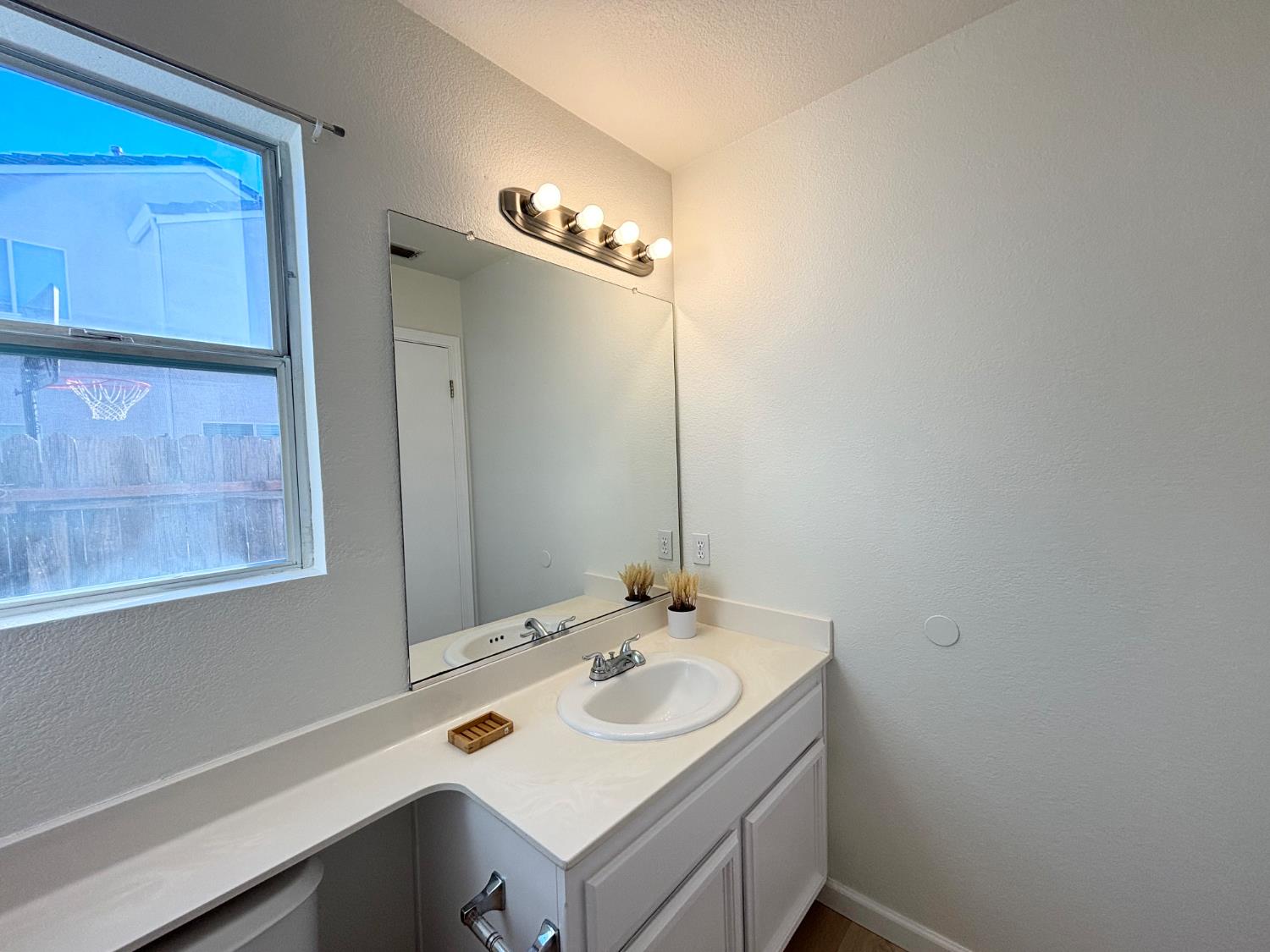 6813 Springridge Way Elk Grove, CA 95758 - Photo 21 of 26 a bathroom with a sink and a mirror