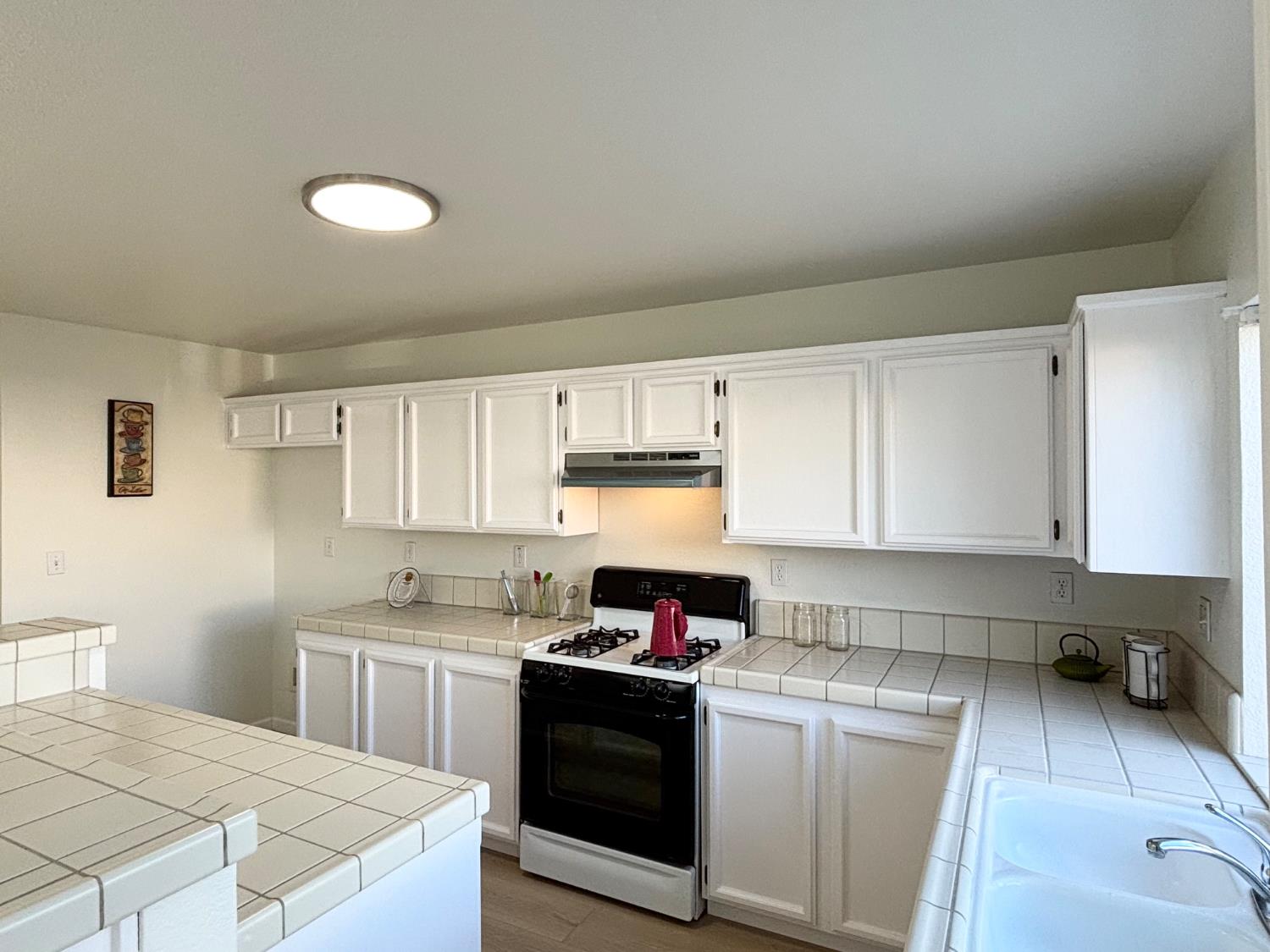 6813 Springridge Way Elk Grove, CA 95758 - Photo 10 of 26 a kitchen with stainless steel appliances granite countertop a stove a sink and a refrigerator
