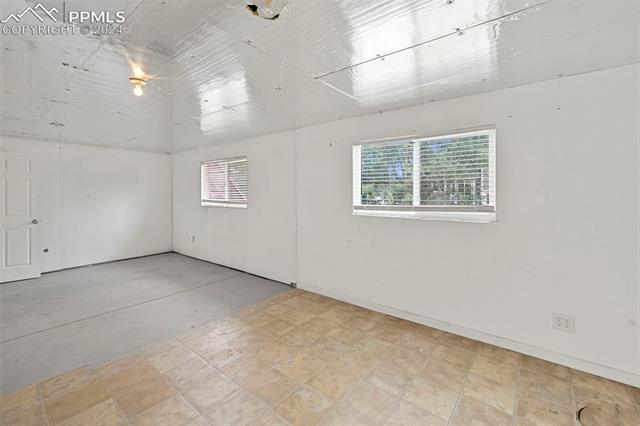 6725 Akron Road Colorado Springs, CO 80923 - Photo 44 of 50 Spare room with light tile patterned floors
