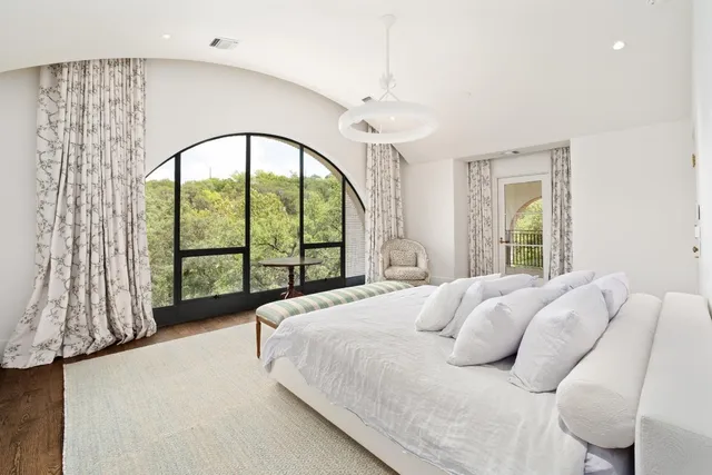 a bed sitting in a bedroom next to a window