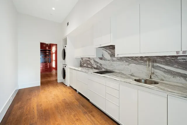 a wooden bench sitting in front of building