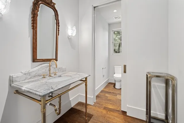 a kitchen with granite countertop white cabinets and sink