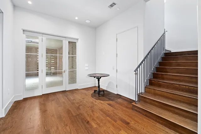 a view of a room with wooden floor and a window