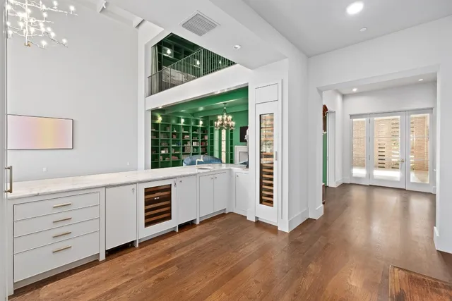 a view of a kitchen with wooden floor and windows