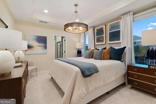 a bedroom with a bed and a chandelier