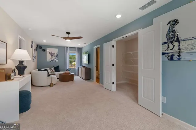 a living room with furniture a chandelier and a walk in closet