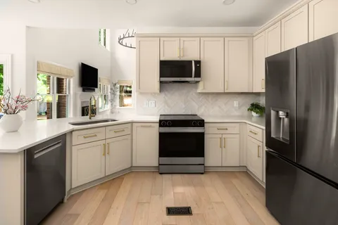 a kitchen with a sink stainless steel appliances and cabinets