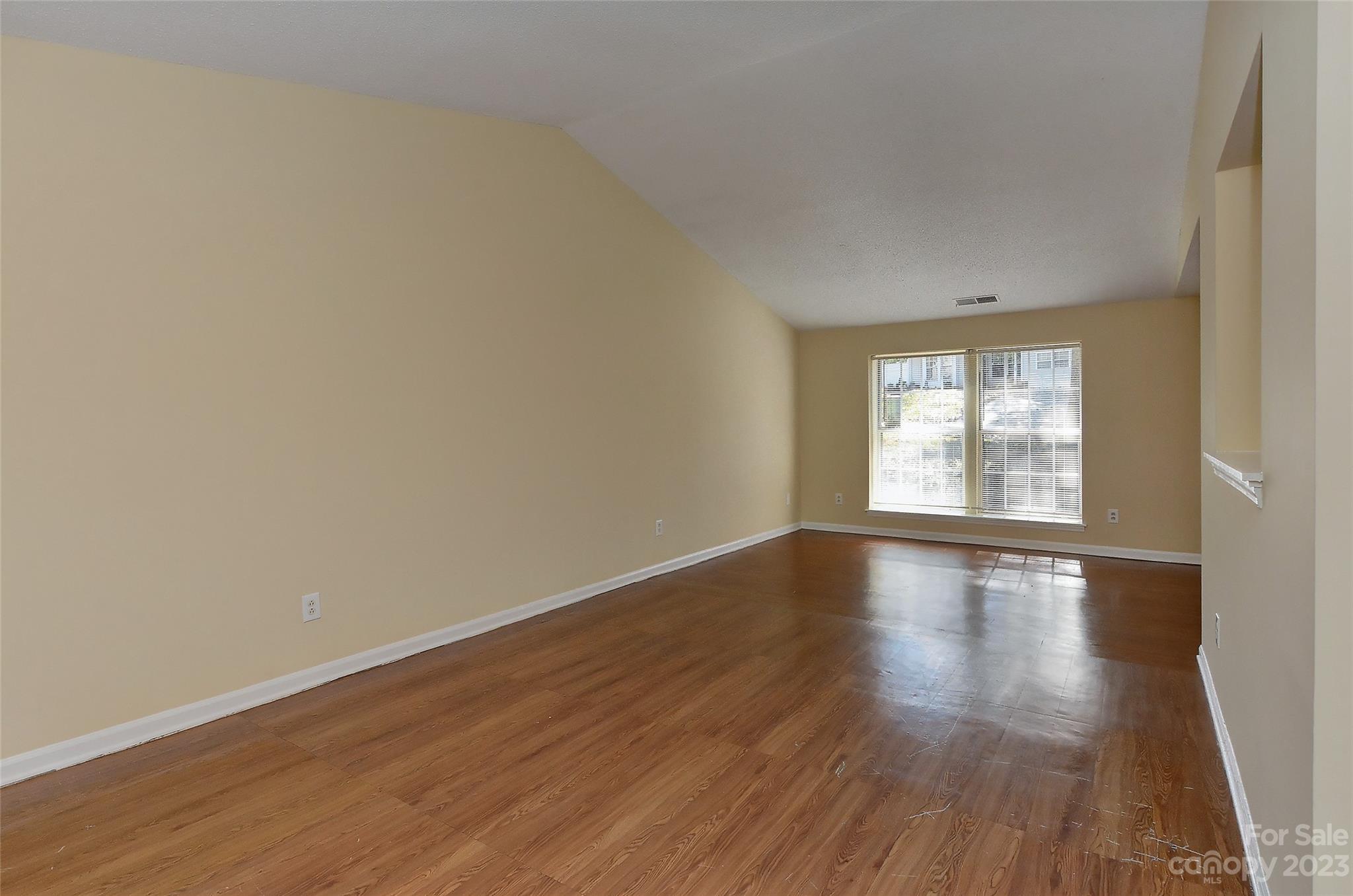 6836 Shiloh Ridge Lane Charlotte, NC 28212 - Photo 11 of 30 a view of an empty room with wooden floor and window
