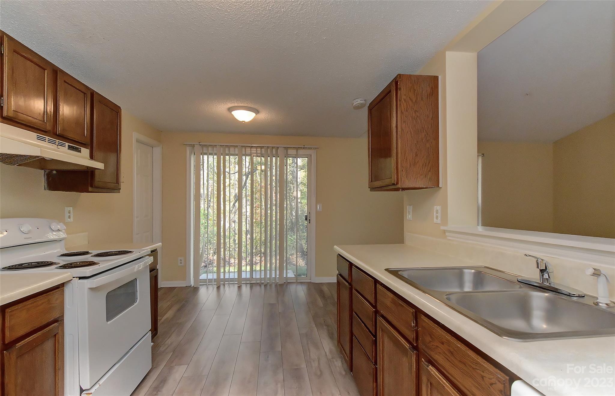 6836 Shiloh Ridge Lane Charlotte, NC 28212 - Photo 15 of 30 a kitchen that has a sink a stove and wooden floor