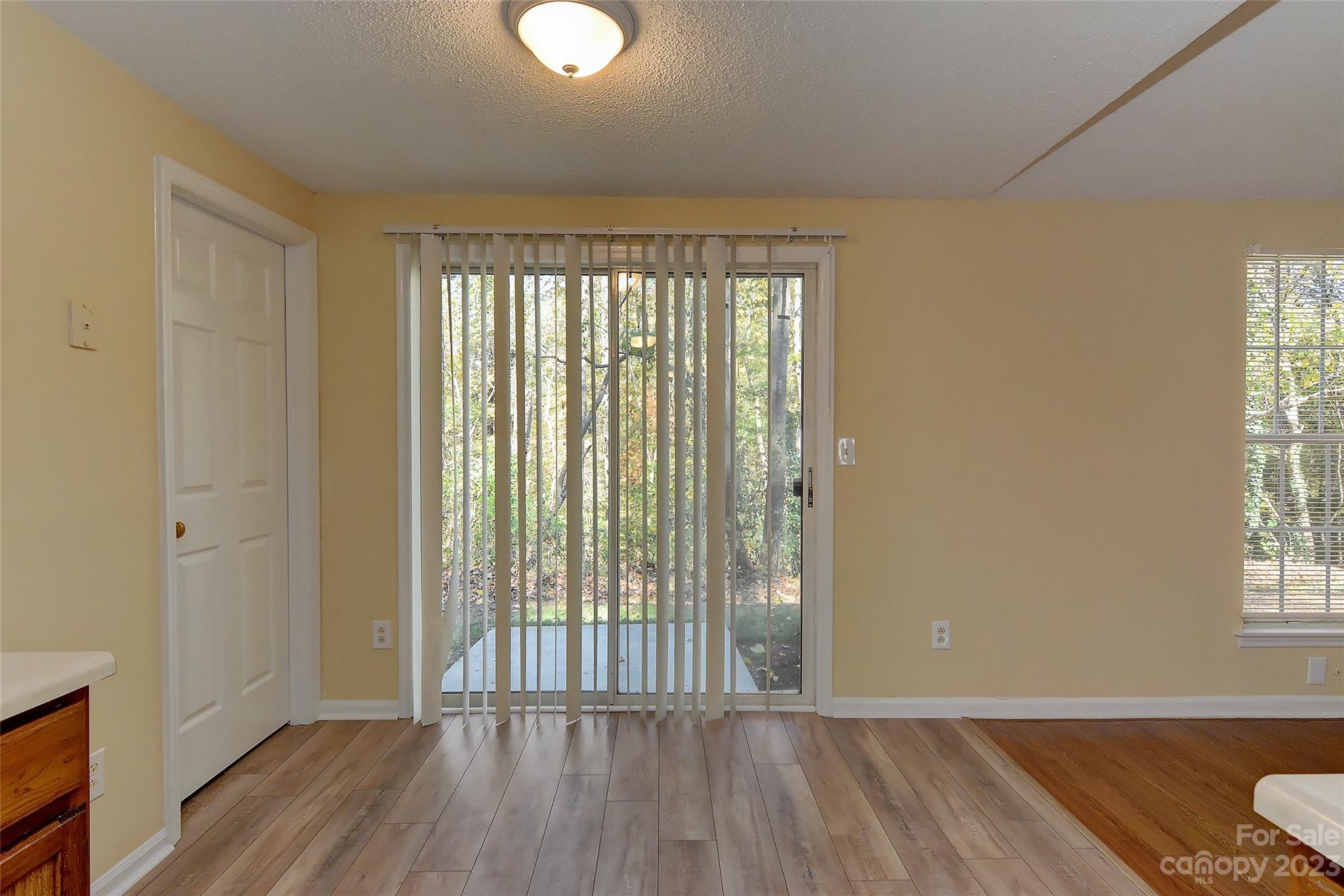 6836 Shiloh Ridge Lane Charlotte, NC 28212 - Photo 16 of 30 an empty room with wooden floor and windows