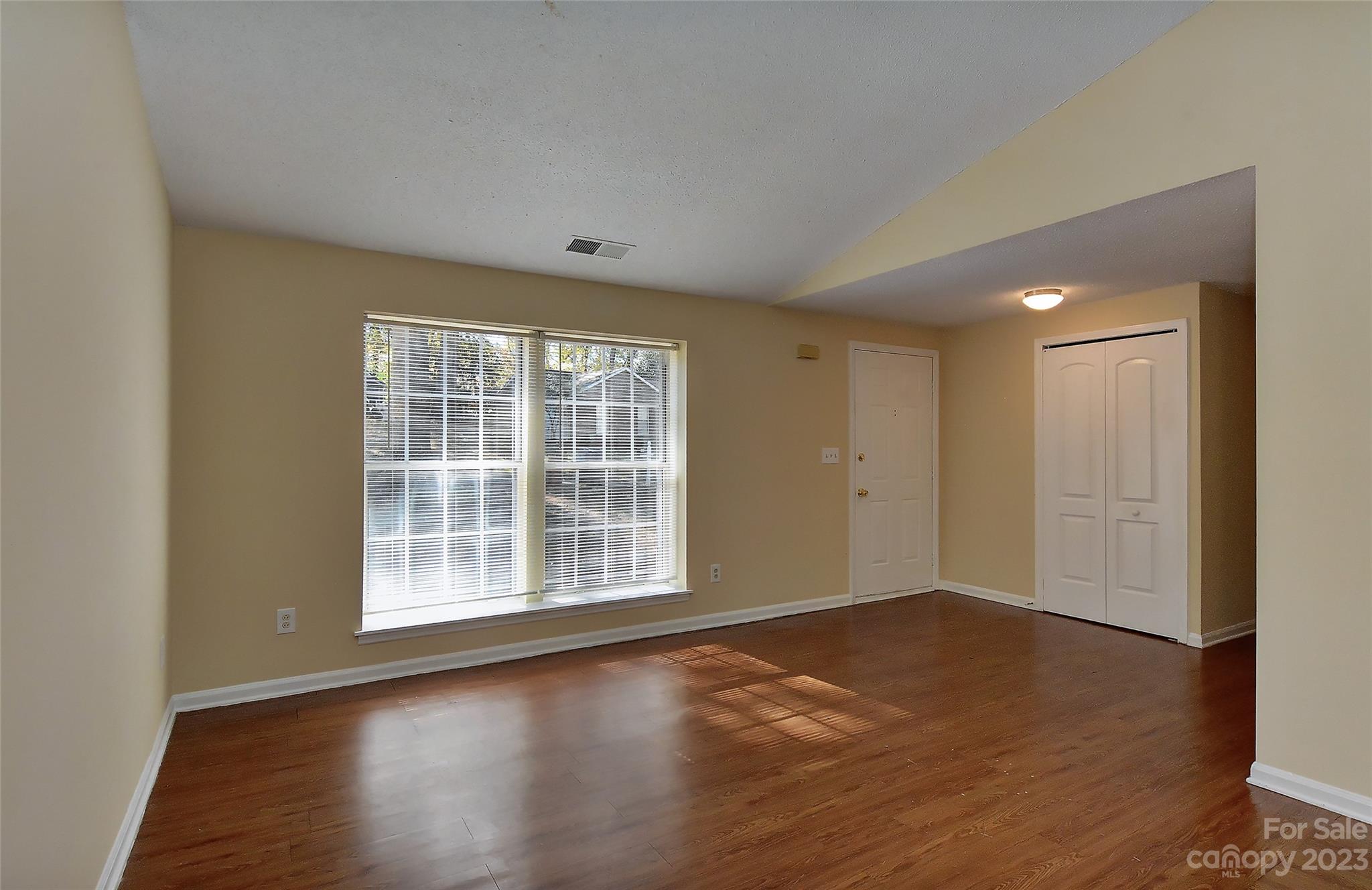 6836 Shiloh Ridge Lane Charlotte, NC 28212 - Photo 6 of 30 an empty room with wooden floor and windows