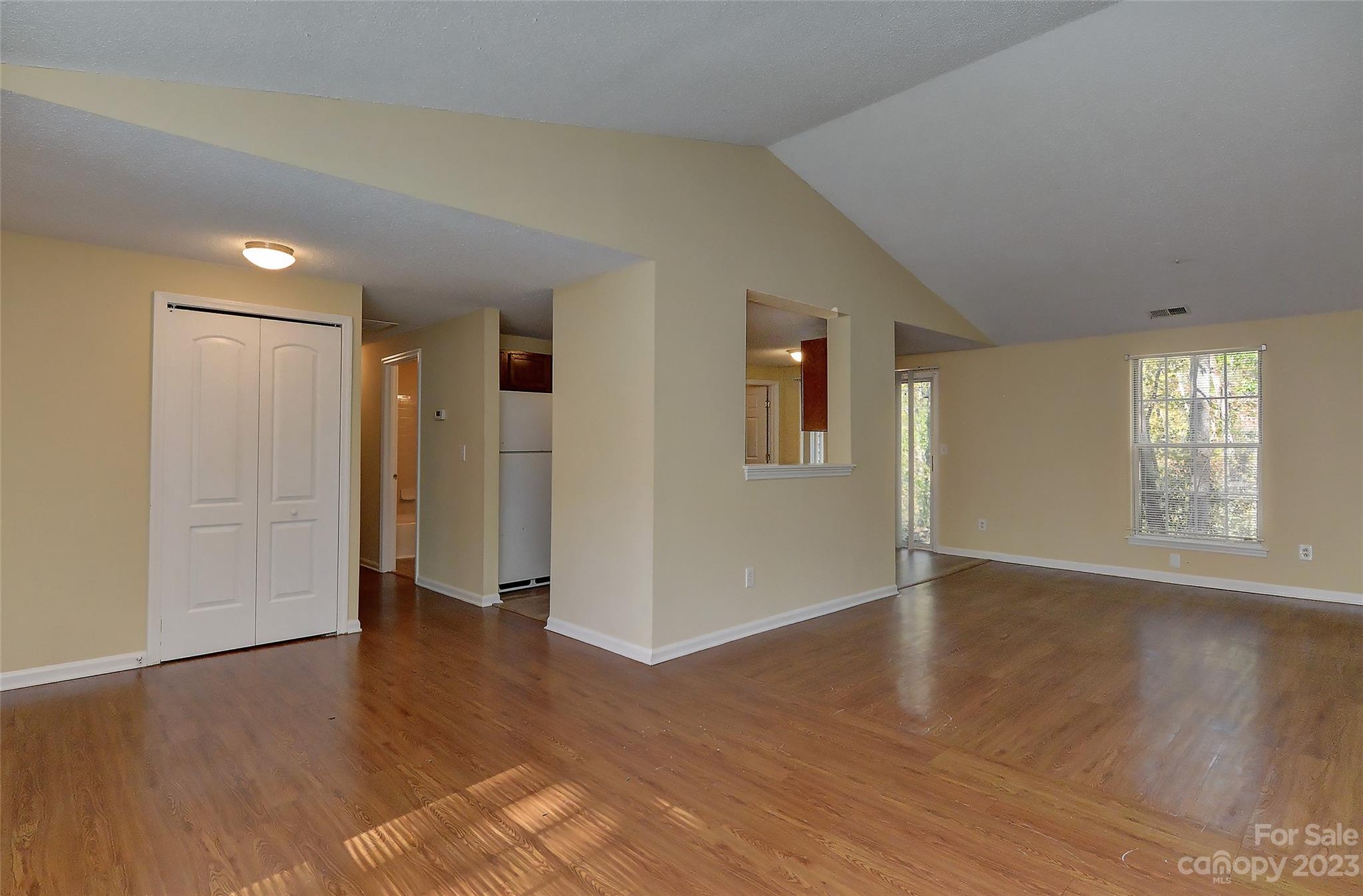 6836 Shiloh Ridge Lane Charlotte, NC 28212 - Photo 7 of 30 an empty room with wooden floor and windows