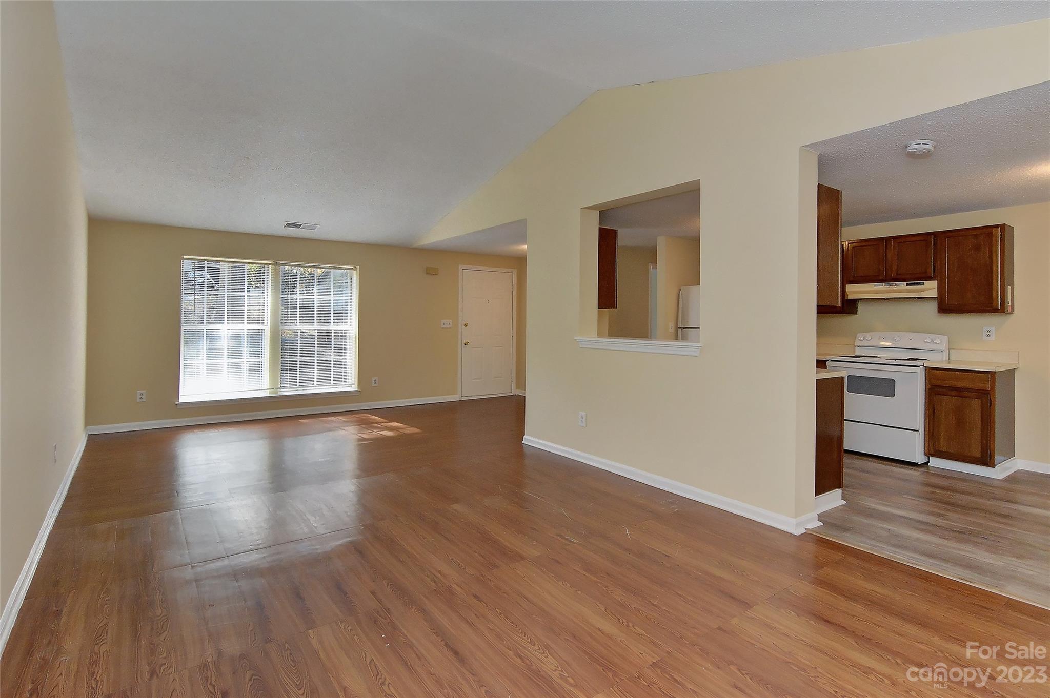 6836 Shiloh Ridge Lane Charlotte, NC 28212 - Photo 10 of 30 a view of an empty room with window and wooden floor