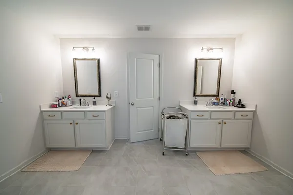 a bathroom with a double vanity sink and mirror