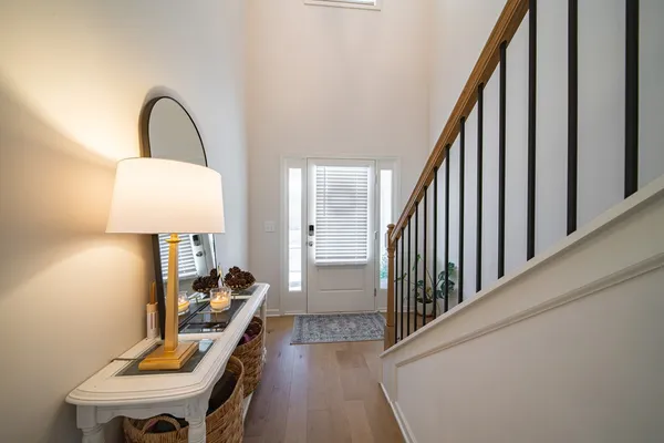 a view of a hallway with a livingroom and furniture