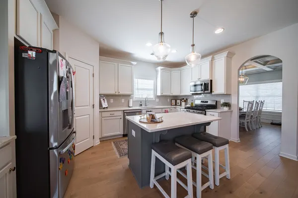 a kitchen with a refrigerator a sink and cabinets