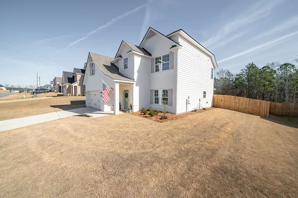 a spacious bathroom with a bed and a chandelier