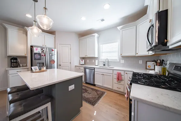 a kitchen with cabinets appliances and a counter top