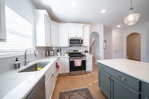 a kitchen with a stove a sink and a refrigerator