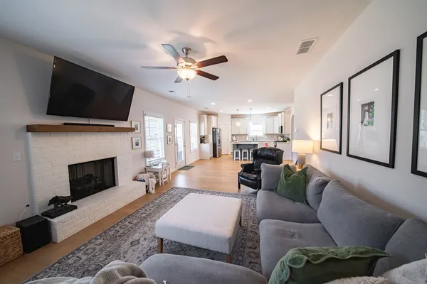 a living room with furniture a fireplace and a flat screen tv