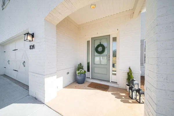 a hallway with a white stove top oven and glass door