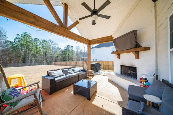 a outdoor living space with furniture and a fireplace